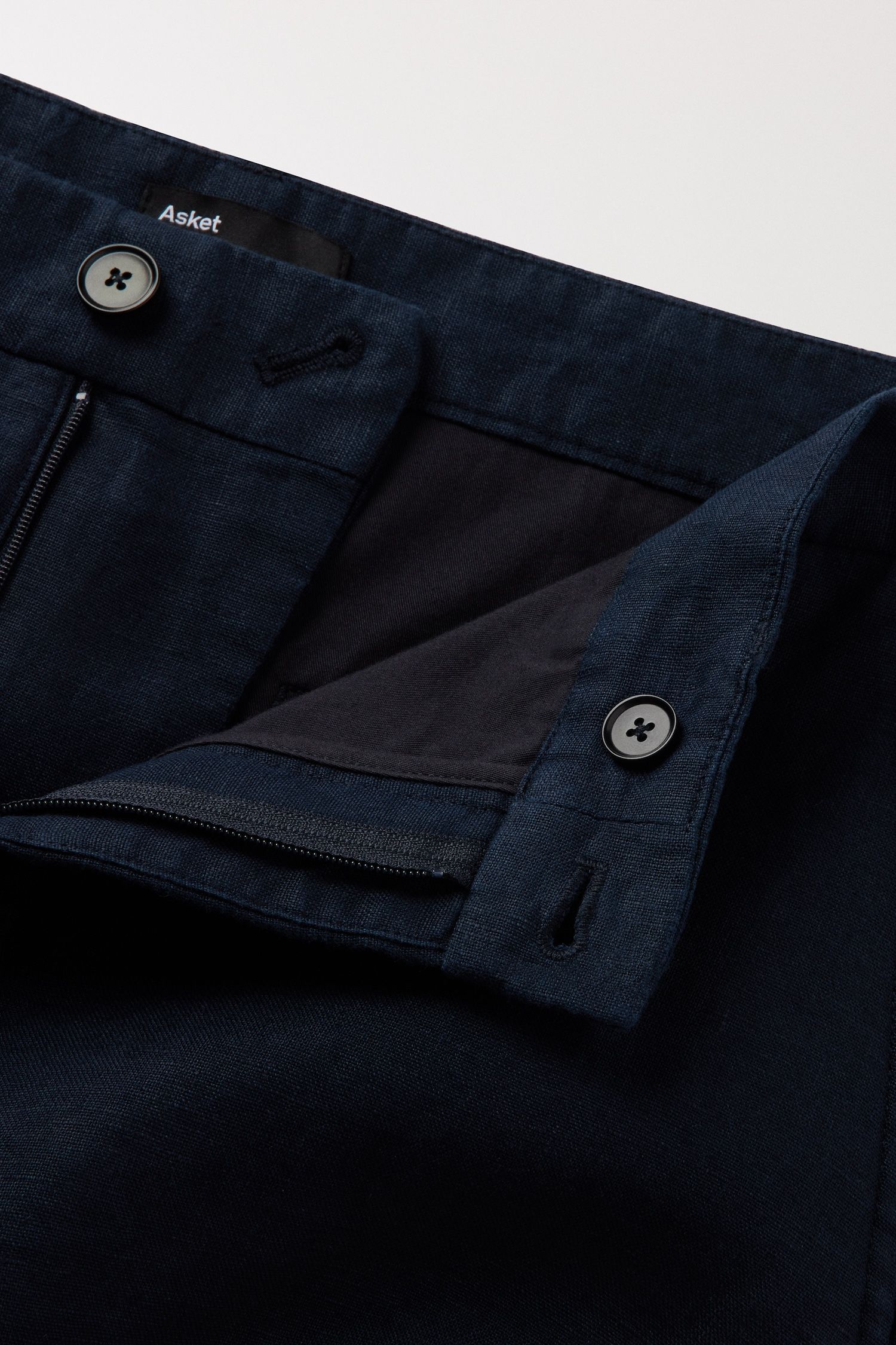 Zip closure with 1 button at the front and 1 button on the inside of the waistband