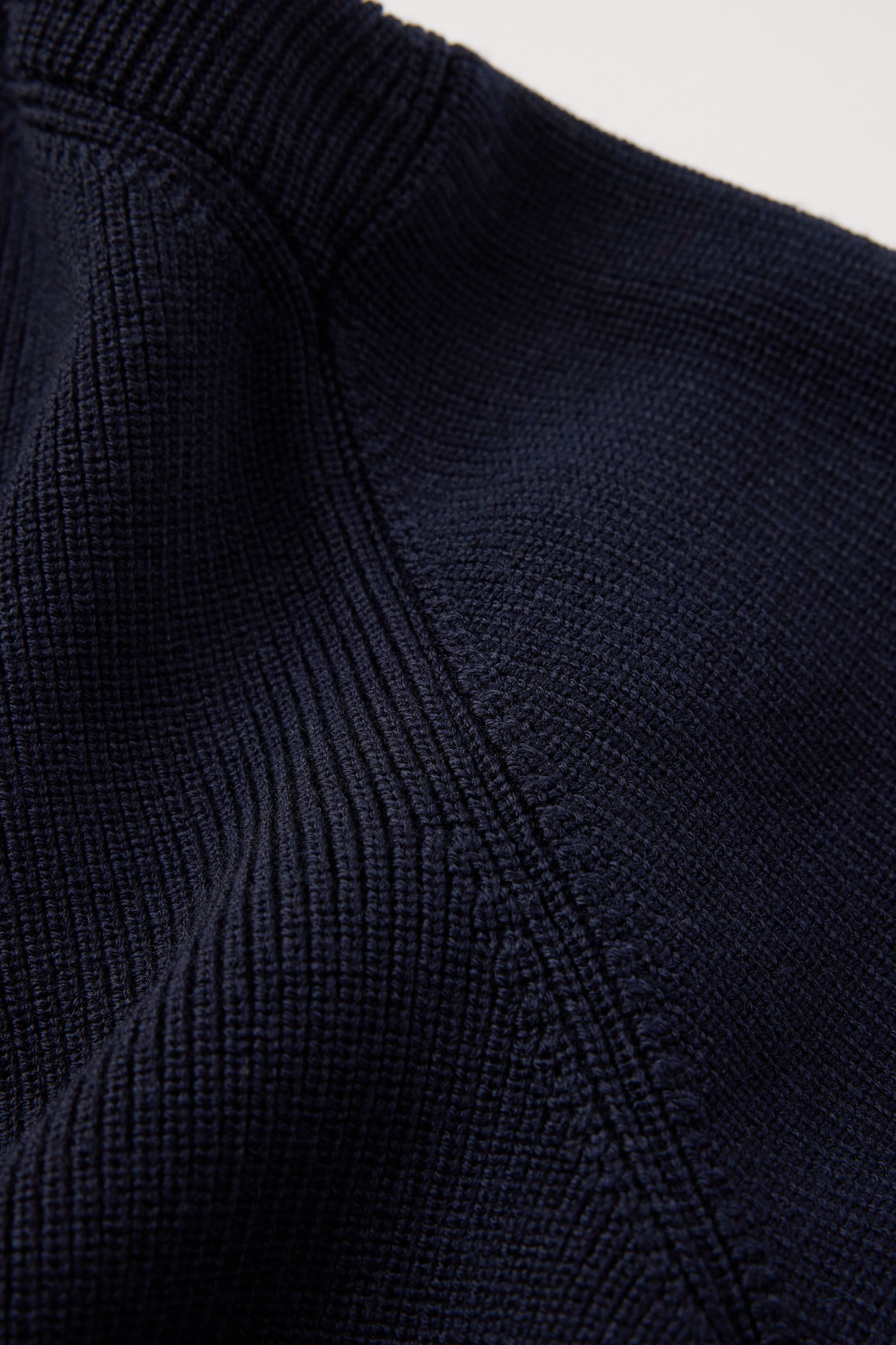 12 gauge half cardigan stitch with fully fashioned details on armhole and neckline