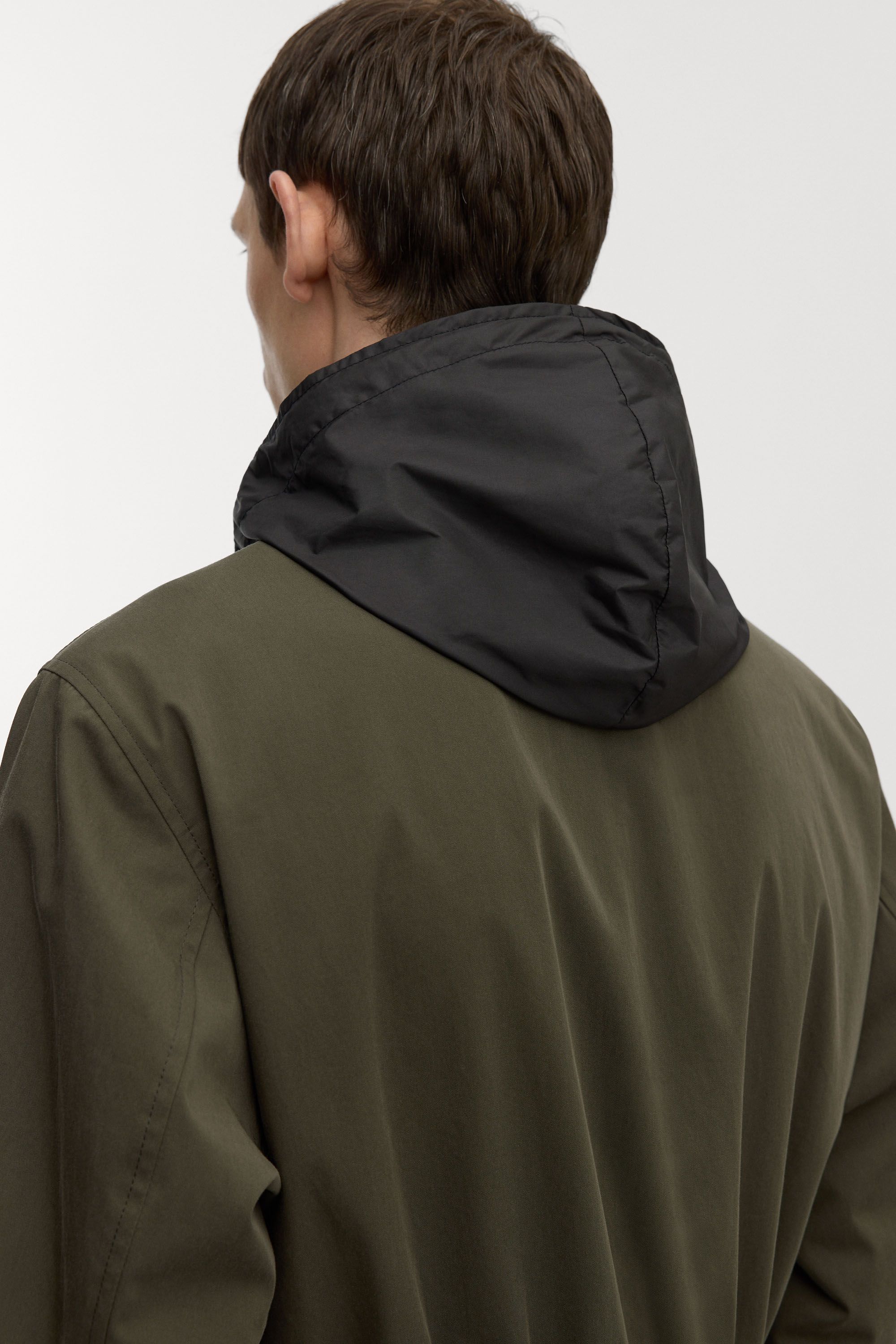 Hidden hood with drawstring and velcro fastening