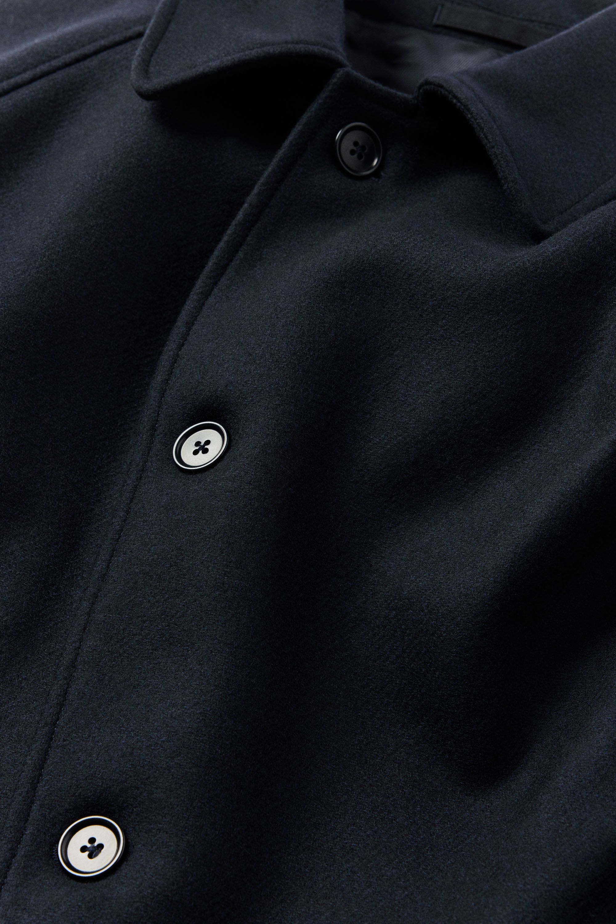 Visible front closure with corozo buttons