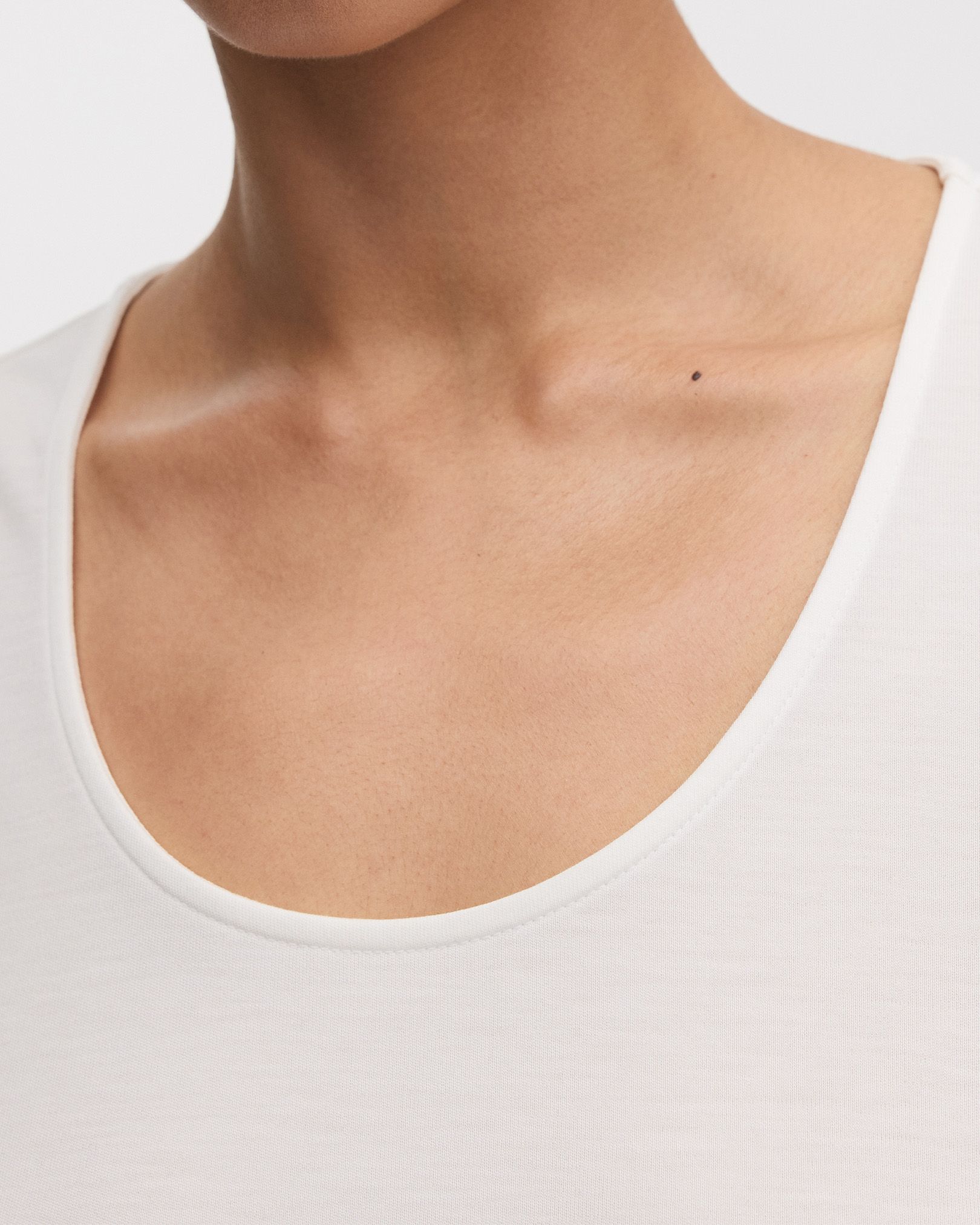 Scooped neckline with refined, top stitched binding