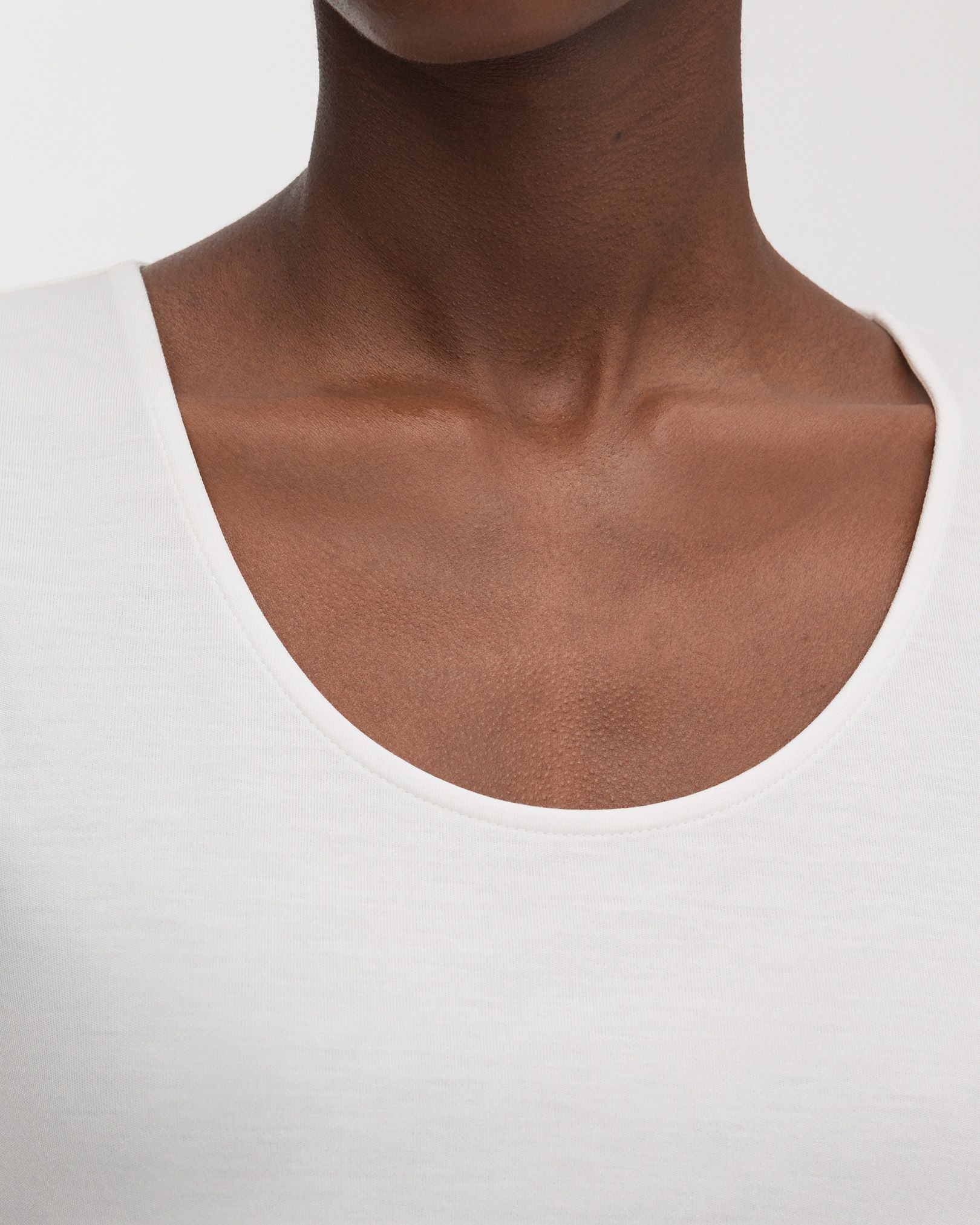 Scooped neckline with refined, top stitched binding