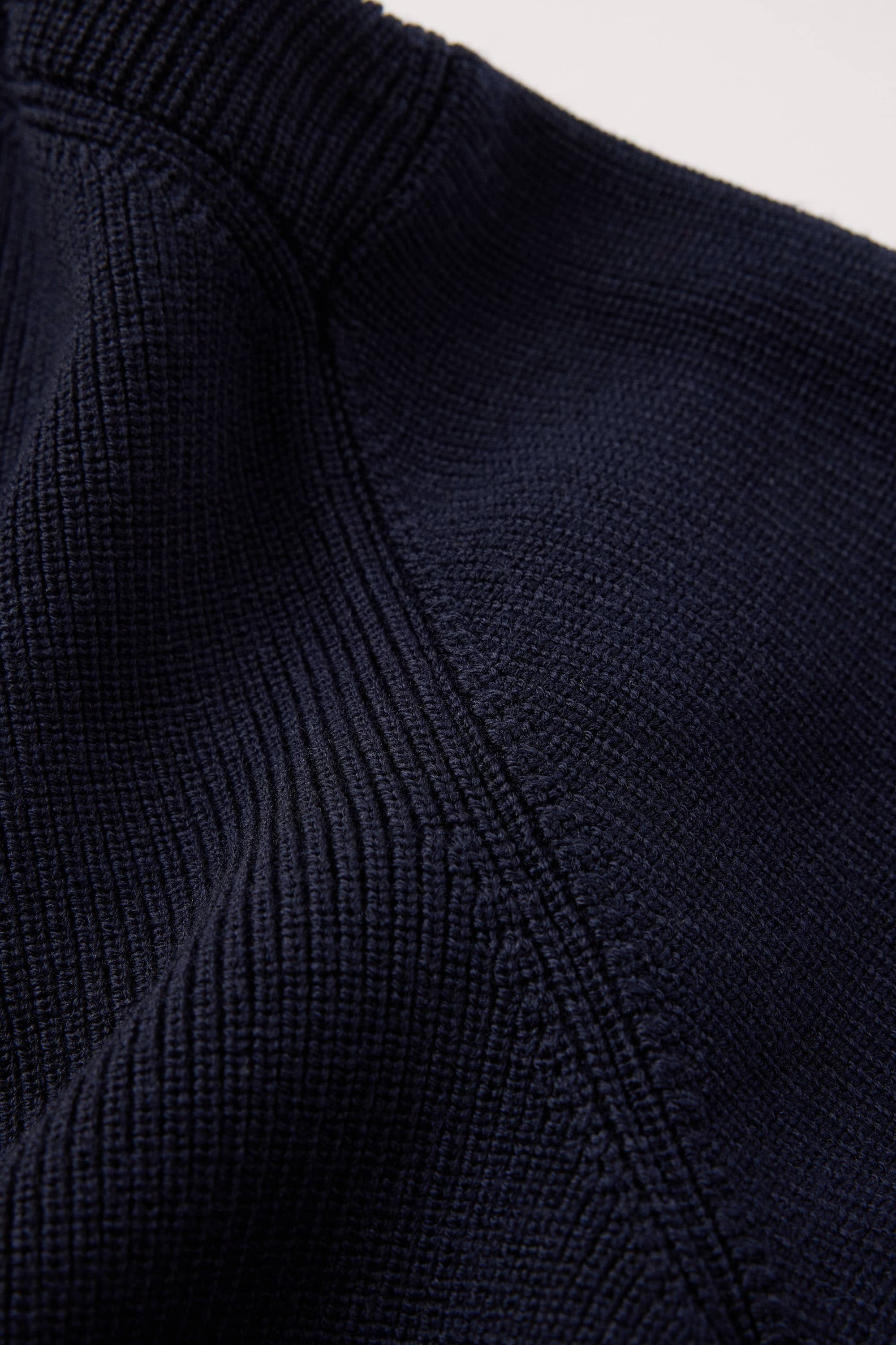 12 gauge half cardigan stitch with fully fashioned details on armhole and neckline