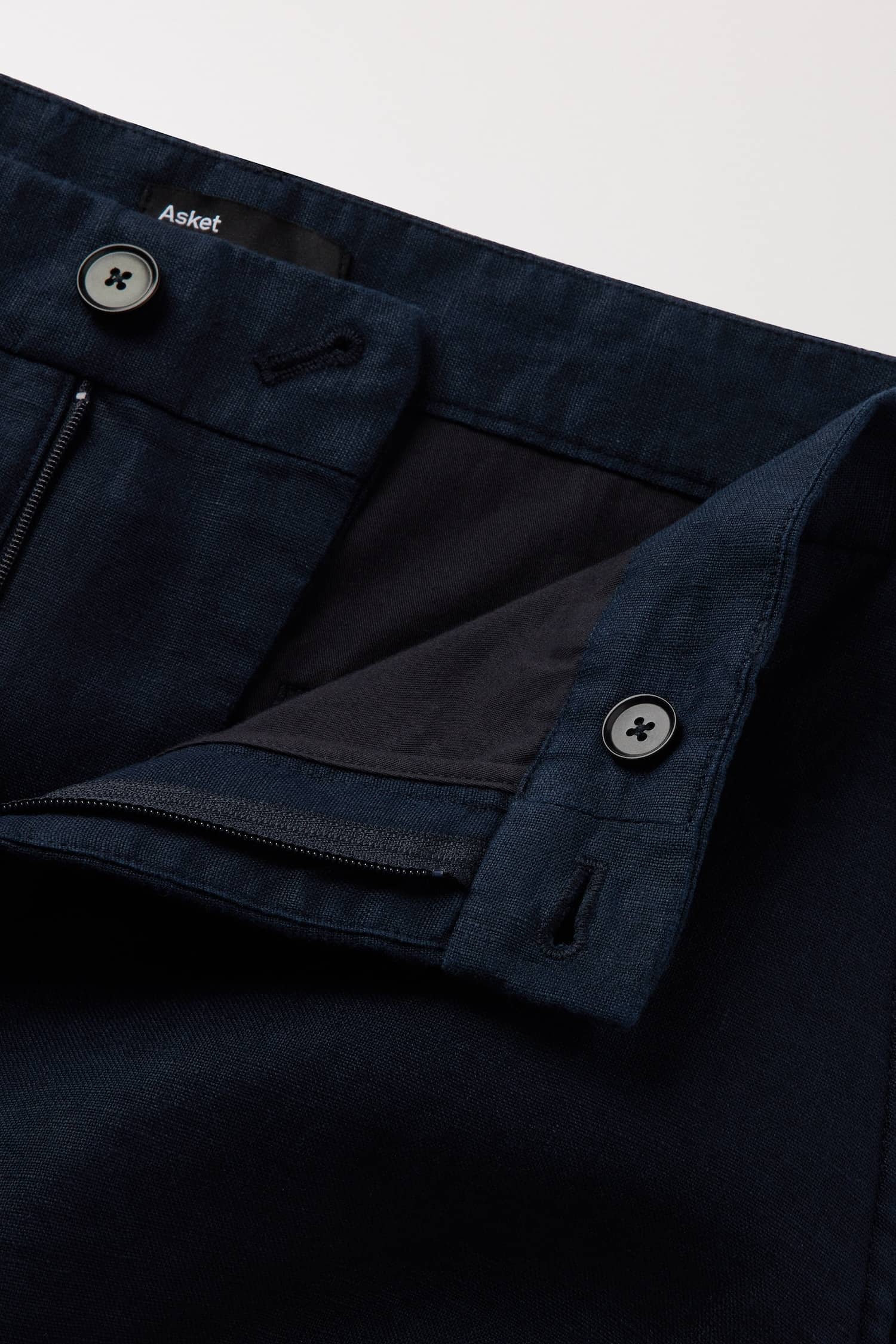 Zip closure with 1 button at the front and 1 button on the inside of the waistband