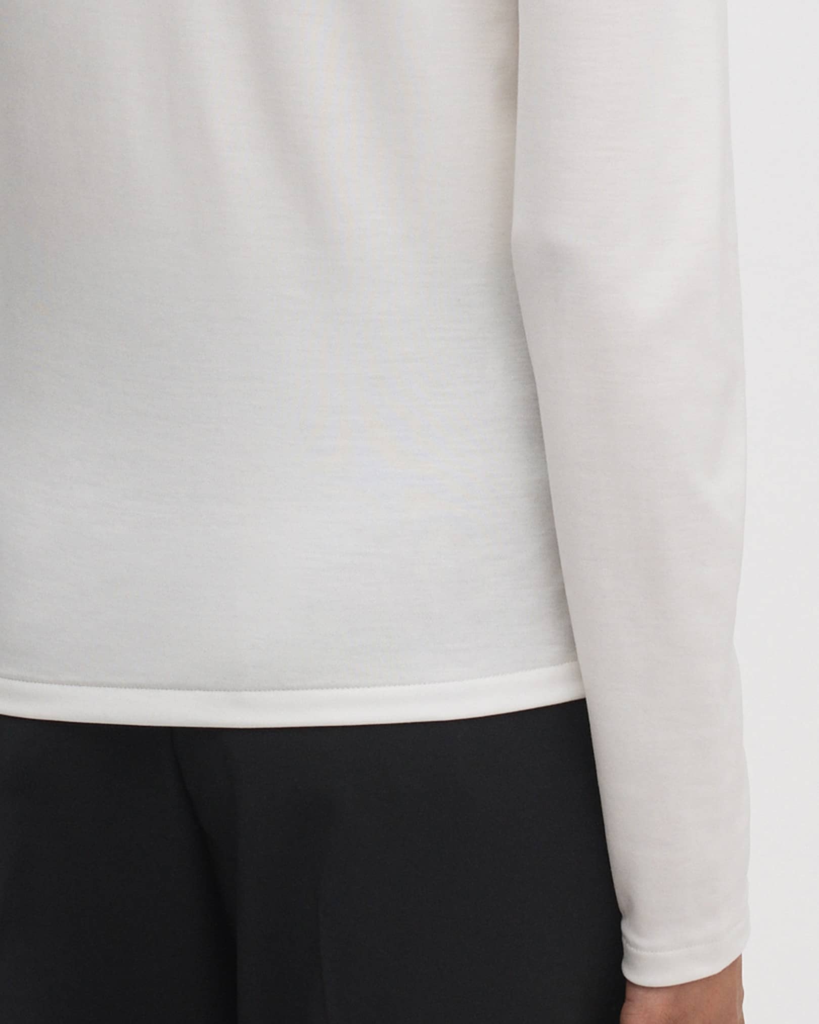 Fine, single-needle coverstitch at hems and cuffs