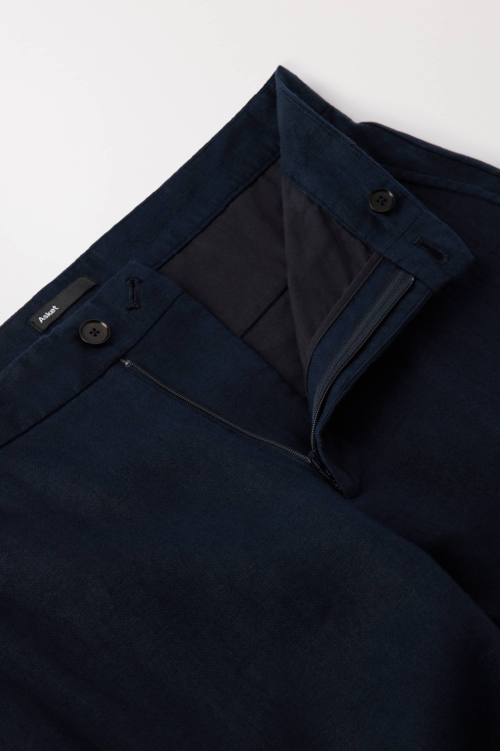 Zip closure with 1 button at the front and 1 button on the inside of the waistband