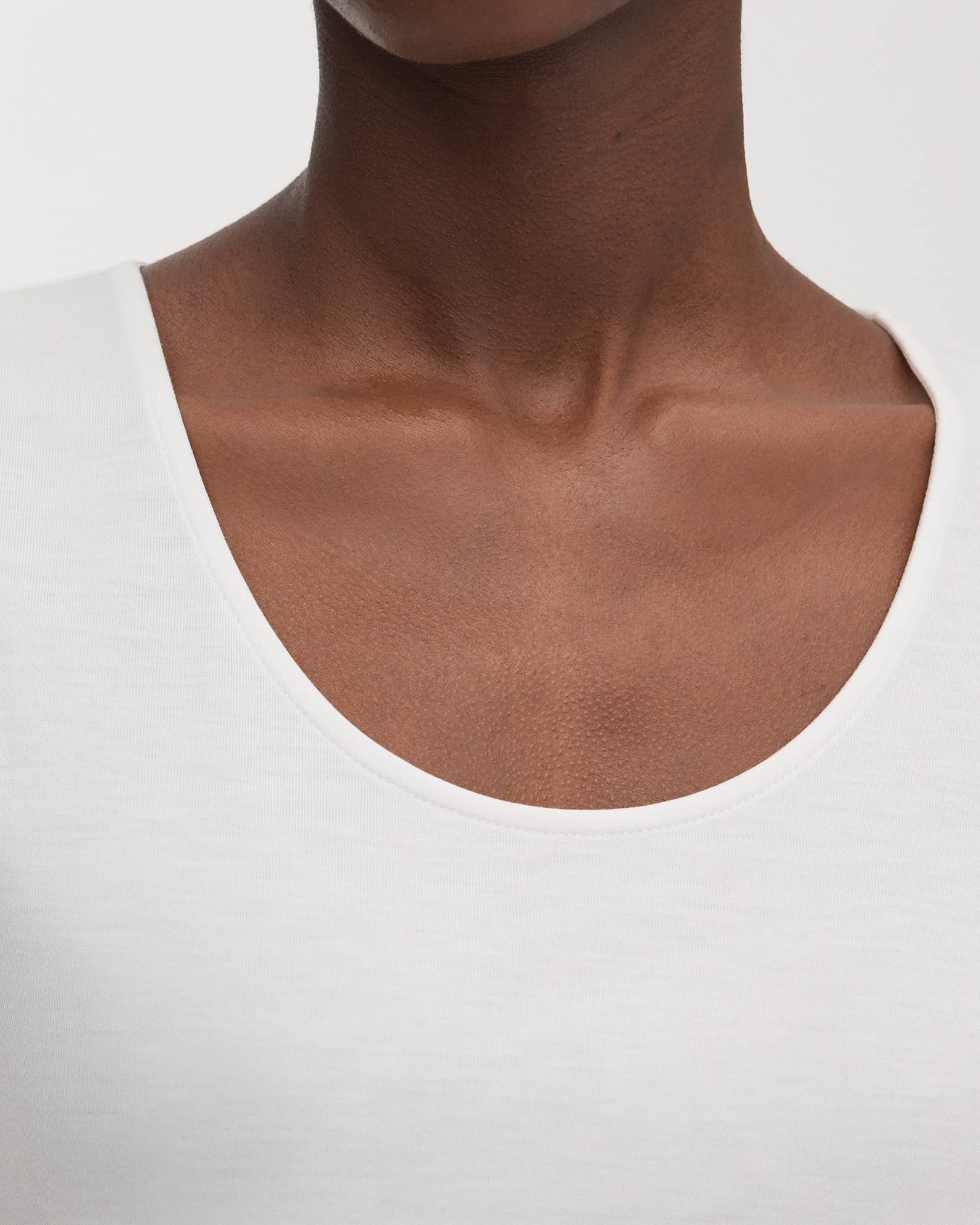 Scooped neckline with refined, top stitched binding