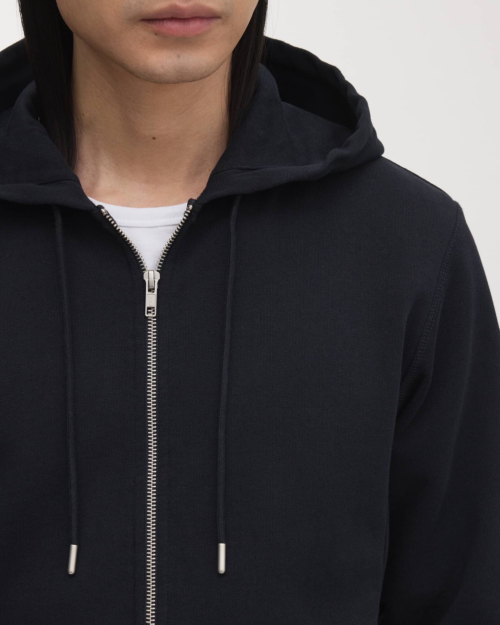 Double lined hood, with tonal drawstrings and brushed metal details